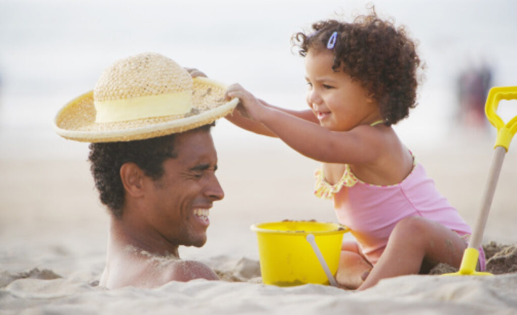 Father and daughter playing on the beach.