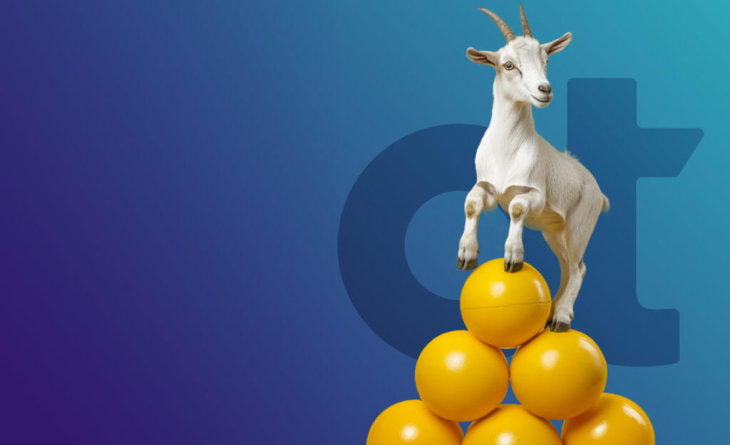 Goat standing on mountain of yellow balls