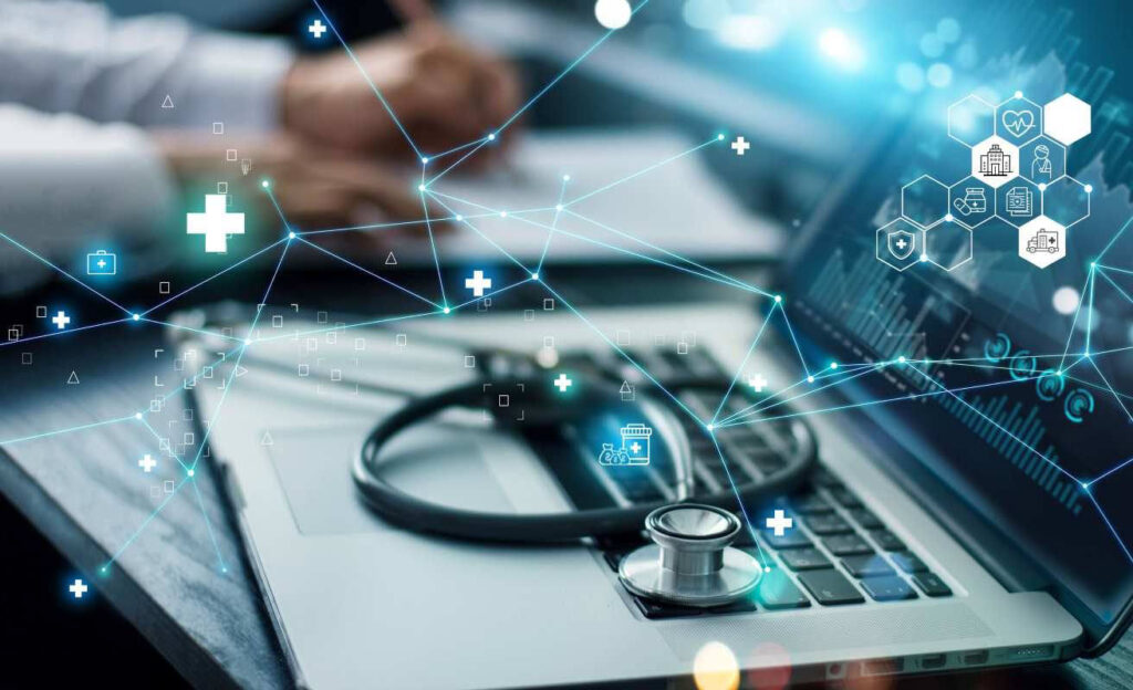 Healthcare worker reviewing data on a laptop
